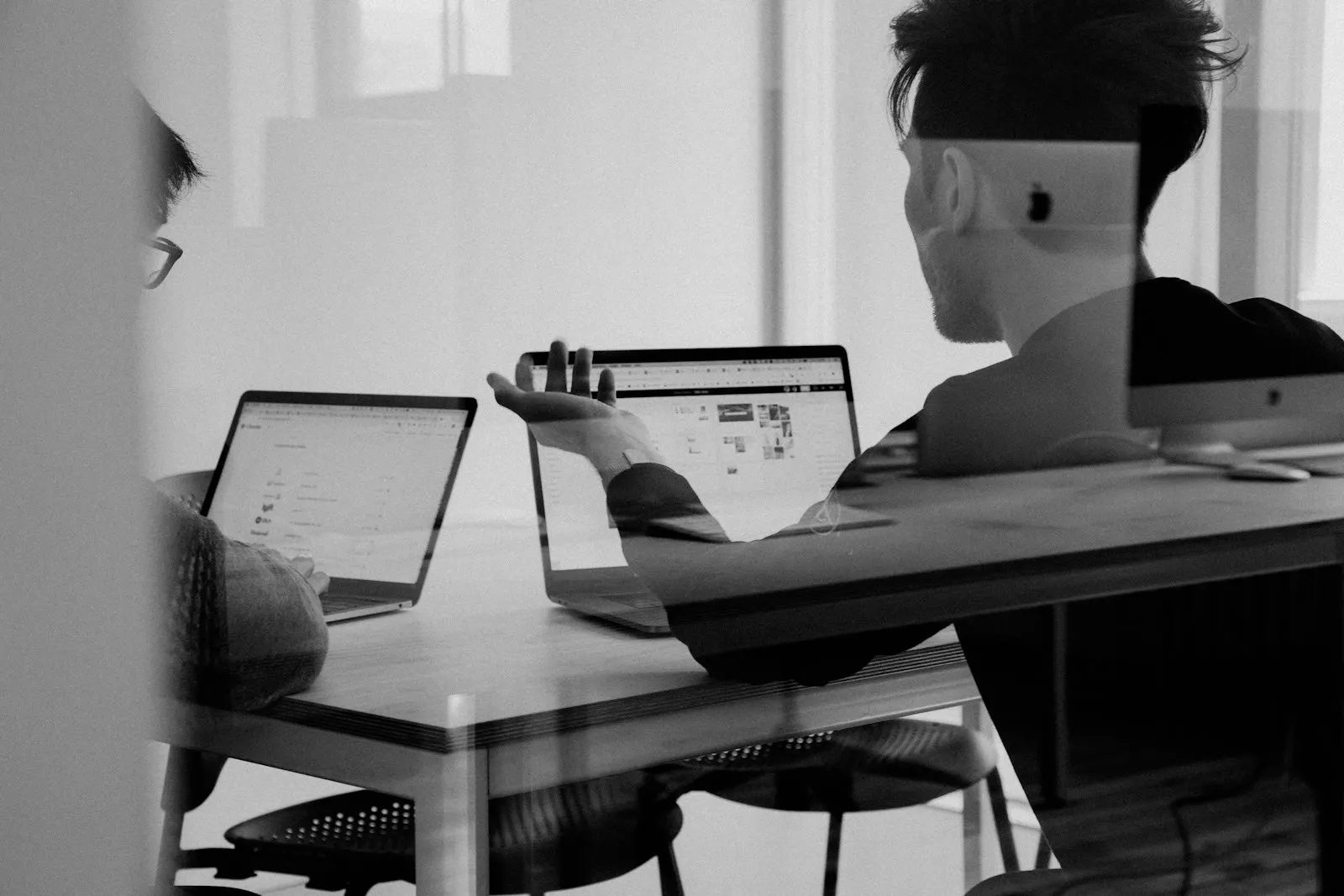 A person working across several screens at a desk
